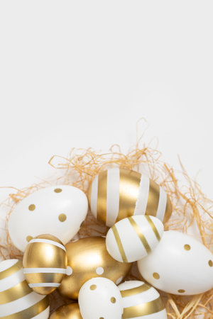 Decorative Easter eggs and straw on a white background.の写真素材