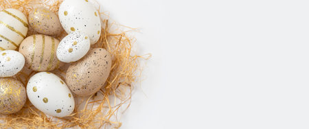 Decorative Easter eggs and straw on a white background.の写真素材