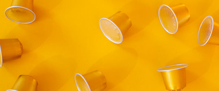 Coffee capsules on a yellow background. Top view, flat lay. Banner.の写真素材