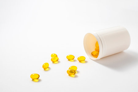 Vitamin omega 3 capsules pills fish on a white background.の写真素材