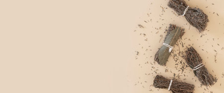 Dry seasoning herbs are tied in bunches on a light background. Top view, flat lay. Banner.