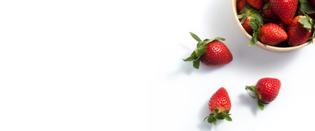 Fresh fruit strawberries in paper packaging on a white background. Top view, flat lay. Banner.の写真素材