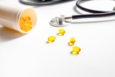 Capsule pills, stethoscope on a white background.の写真素材