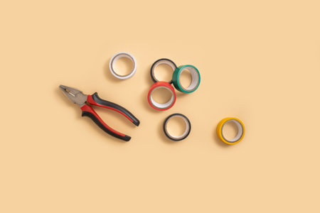 Pliers, electrical tape on a light background. Top view, flat lay.の写真素材