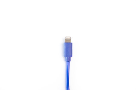 Blue USB charging cable compatible with mobile phones on a white background. Top view, flat lay.の写真素材