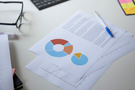 Colorful fractional circles are arranged in a pie chart on the desktop. Top view, flat lay.