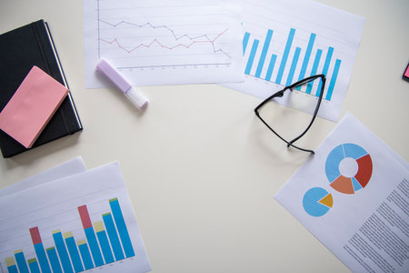 Diary, charts, glasses on the desktop. Top view, flat lay.の写真素材