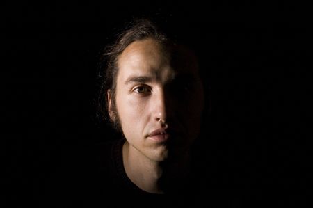 close-up portrait of young man, isolated on blackの写真素材