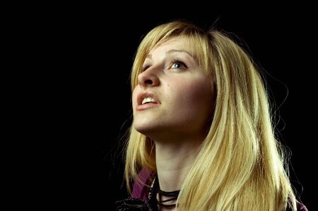 Portrait of a young blonde girl in the blackの写真素材