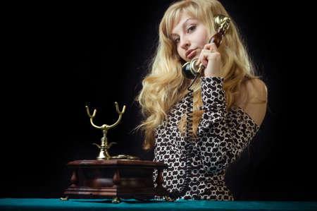 beautiful caucasian woman talking on retro phone.の写真素材