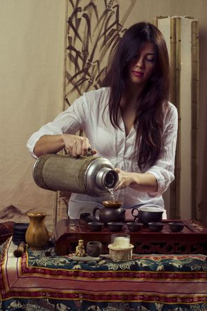 A young girl holds a Chinese tea ceremonyの写真素材