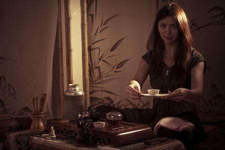 A young girl holds a Chinese tea ceremonyの写真素材
