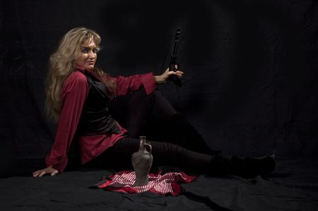 portrait of a young girl in a red shirt with a gunの写真素材