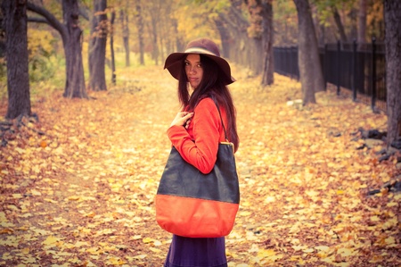 fashion girl standing in the autumn forestの写真素材