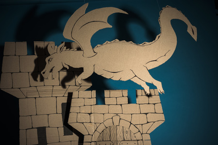 photo of dragon  flying upper the castle made of cardboardsの写真素材
