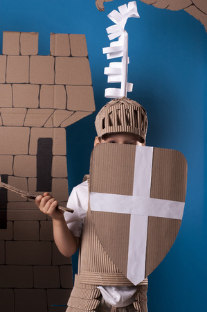 photo of the boy in medieval knight costume made of cardboards. this decorations are made specially for this photosession by me.の写真素材