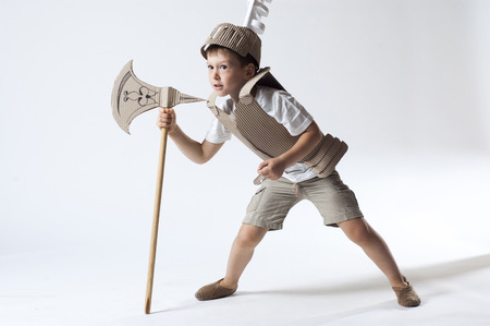 photo of the boy in medieval knight costume made of cardboardsの写真素材