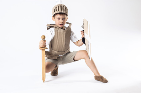 photo of the boy in medieval knight costume made of cardboardsの写真素材