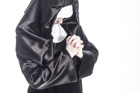 Young nun prays. Photo on white background.の写真素材