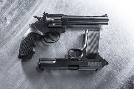 semiautomatic pistol and revolver on metal background.の写真素材