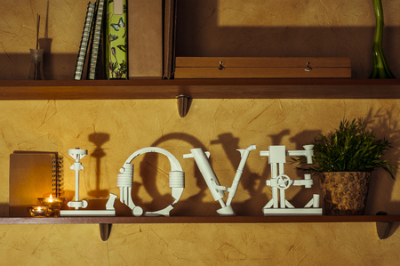 Diy love word made of paper standing on a bookshelf. の写真素材