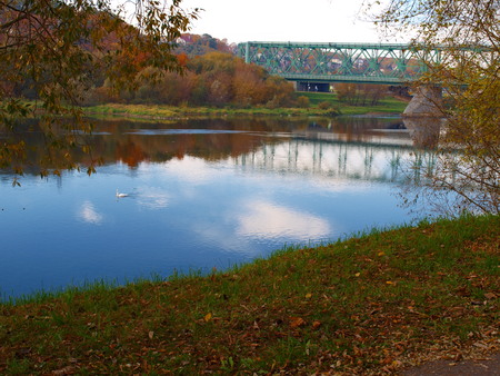 Old green railway bridge across the river