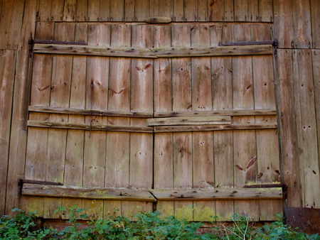 Large wooden doors of the old barn with iron canopiesの写真素材