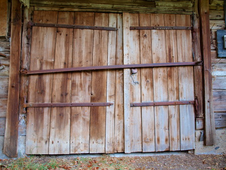 Large wooden doors of the old barn with iron canopiesの写真素材