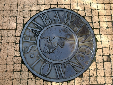 A manhole cover on a pedestrian walkwayの写真素材
