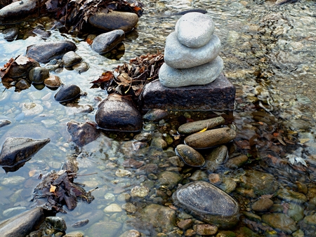 Stones and fallen leaves in the streamの写真素材