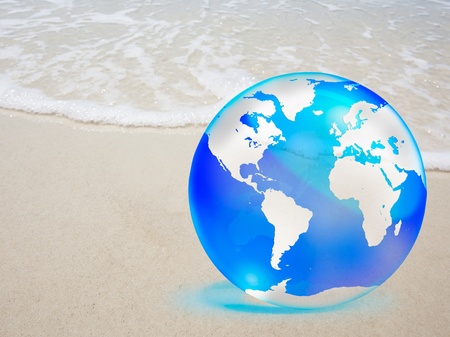 crystal globe over sand and  seaの写真素材