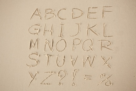 The alphabet written in sand on a beach.の写真素材