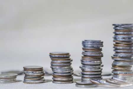 Financial investment concept, Double exposure of city night and stack of coins for finance investor,...
