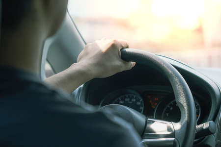 Man with car steering wheel is ready on the move in the modern life style.の写真素材