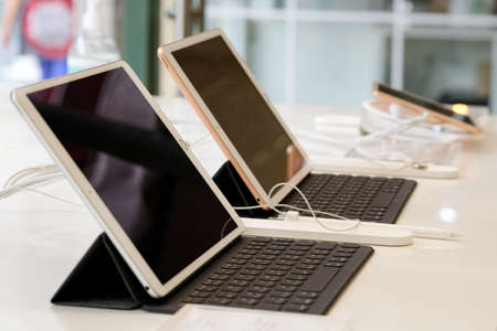 Tablet computer and mobile phone on the table in the office.