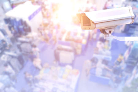 CCTV security camera on blurred background of shopping mall with bokeh.