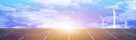Solar panels and wind turbines on blue sky background. Alternative energy concept.