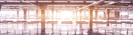 Empty parking lot or garage interior with concrete stripe painted columns. Automotive industry and...