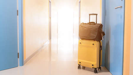 Yellow suitcase with sun glasses, Prepare to board the plane, Travel-related content.の写真素材