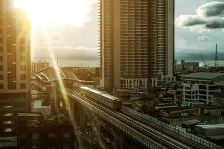 Bangkok, Thailand - September 9, 2021 : The Sky train in Bangkok with building, BTS Sky Train on rail tracks with traffic underneath, Aerial view of Bangkok modern office buildings and condominium.のeditorial素材