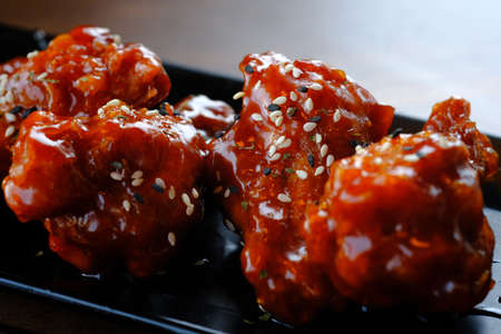 Grilled Chicken Wings, tasty grilled chicken wings on a white dish, top view, baked barbecue chicken wings with white sesame, flat lay.の写真素材