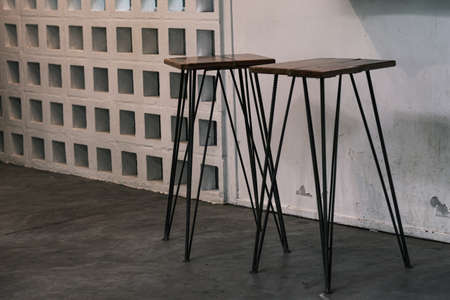 Tall table - Wooden table steel legs simplistic, tall bar stools in stylish kitchen with wooden cupboards.の写真素材