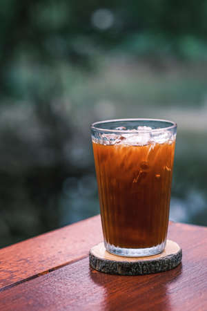 Americano, Cold brewed coffee, Composite image of white coffee mug, Hot coffee (Americano) on wooden table in relax morning.の写真素材