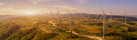 wind turbines in a field, wind turbine farm sundown, Wind Power Turbines in a rural area, Tracking shot of energy producing wind turbines in Oregon.の写真素材