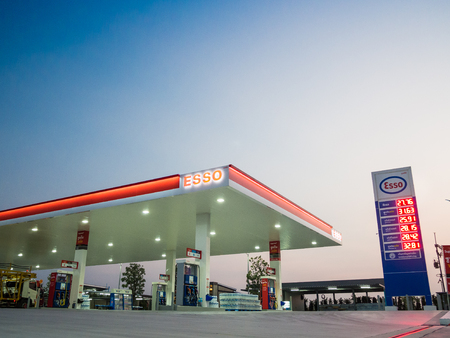 Si Racha, Chonburi /Thailand - April 18, 2018: Esso gas station blue sky background during sunset in...