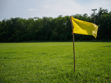 yellow flag at corner of soccer field. sport flag and sign concept.の写真素材