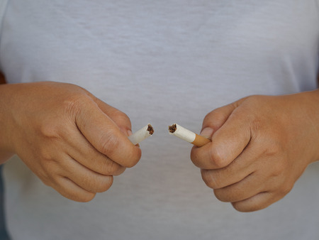 Female hand crushing cigarette, Concept Quitting smoking,World No Tobacco Day.の写真素材