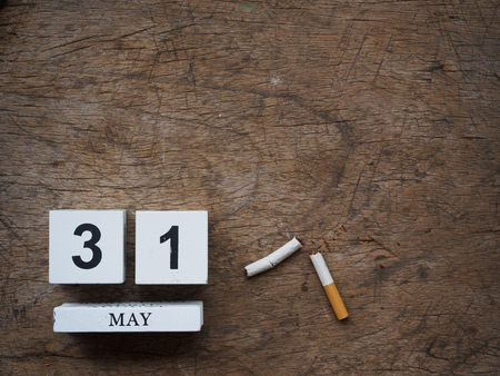 31 MAY wooden calendar block and broken cigarette on wooden texture background top view. World no tobacco concept.の写真素材