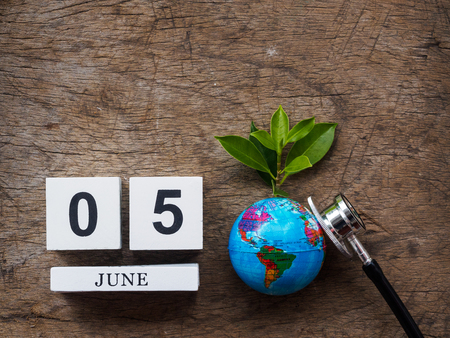 05 JUNE wooden calendar block, globe and stethoscope on wooden texture background top view. World Environment day concept.の写真素材
