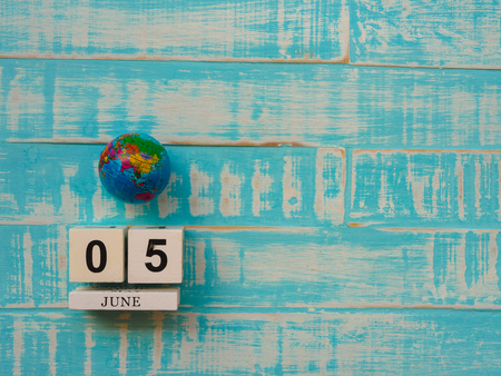 05 JUNE wooden block calendar globe and stethoscope on blue wooden background.の写真素材